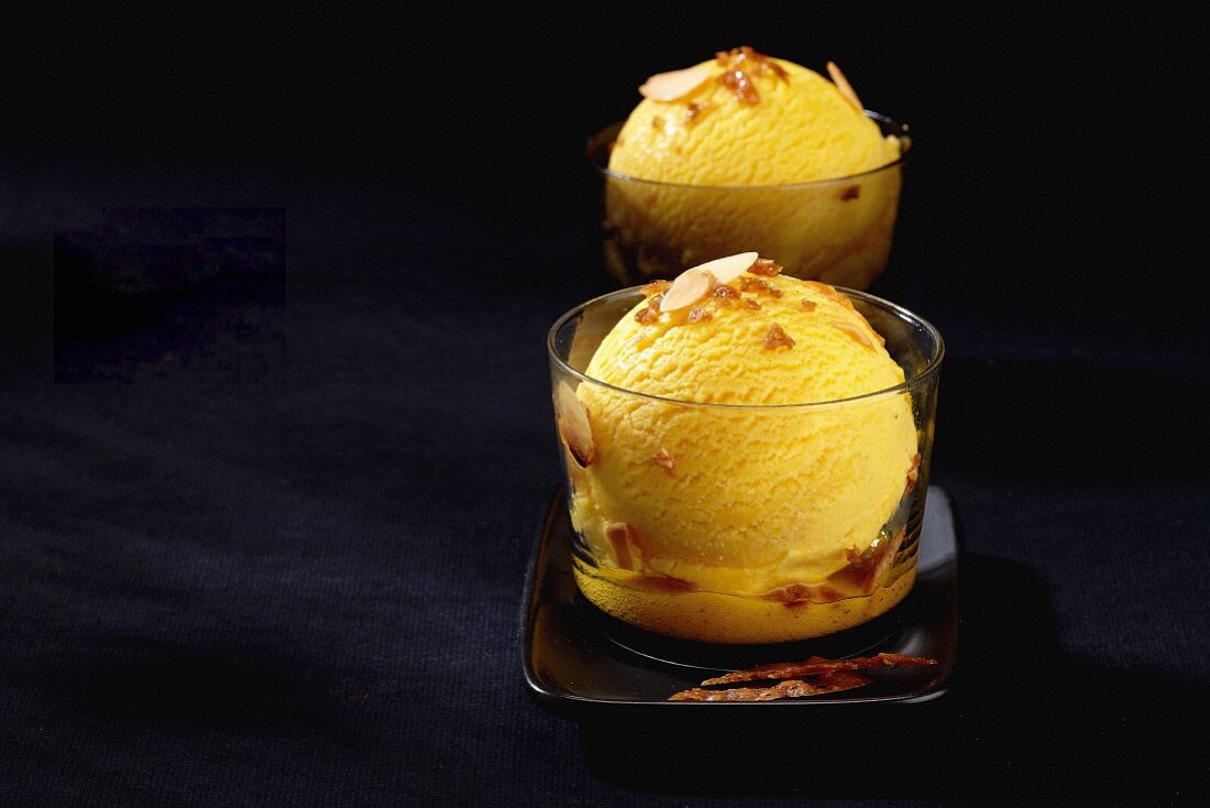Mango ice cream with flaked almonds