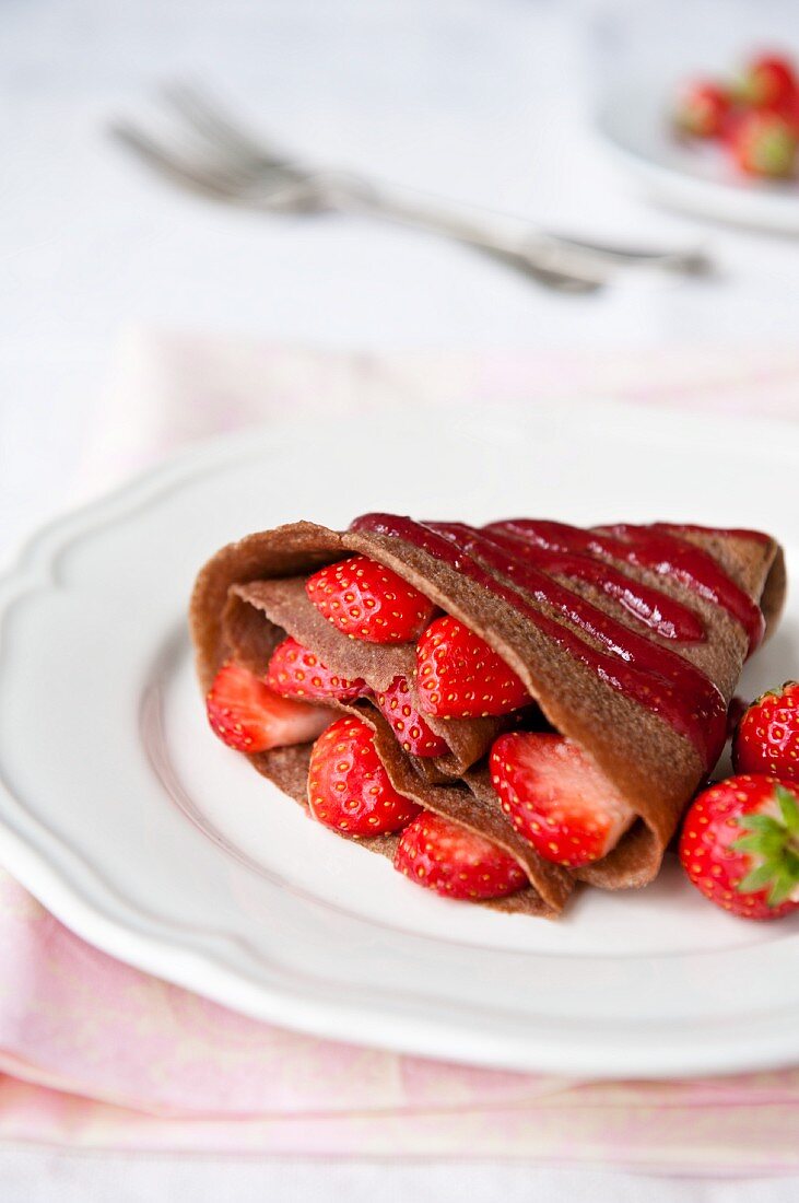 A chocolate crepe with raspberries