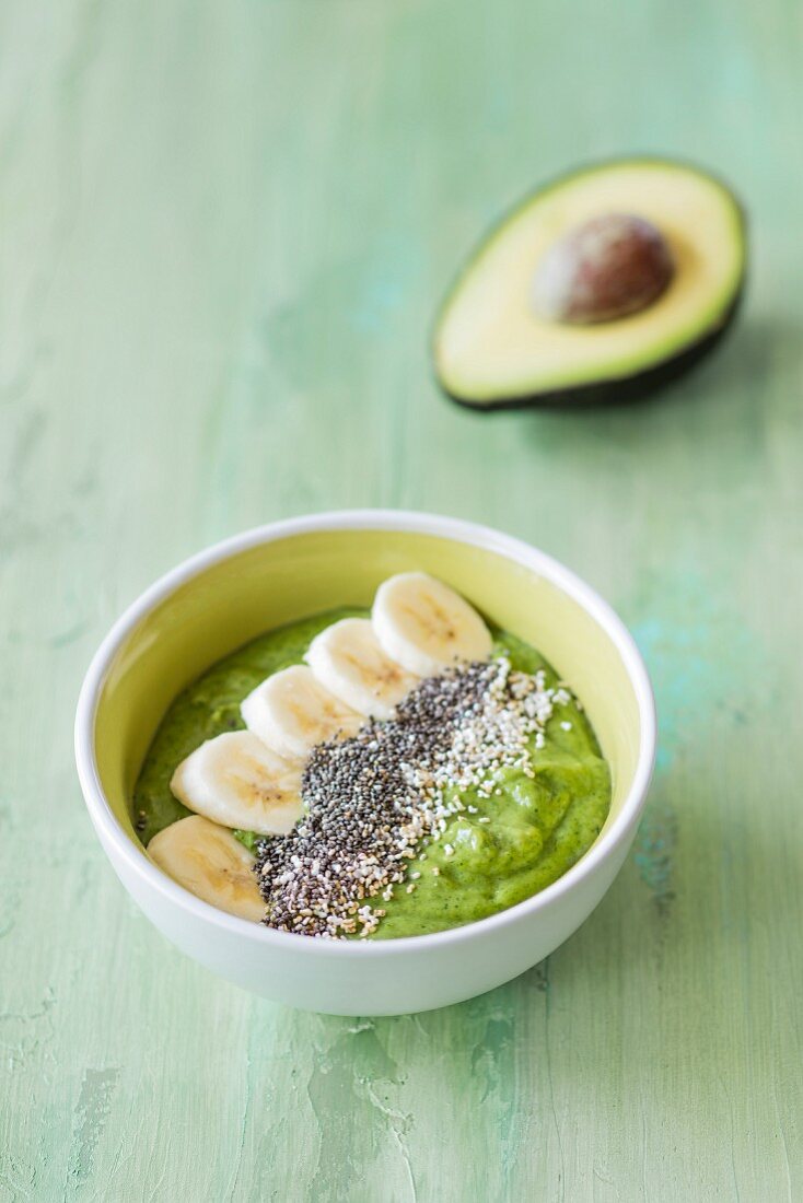 A smoothie bowl with avocado, spinach and banana