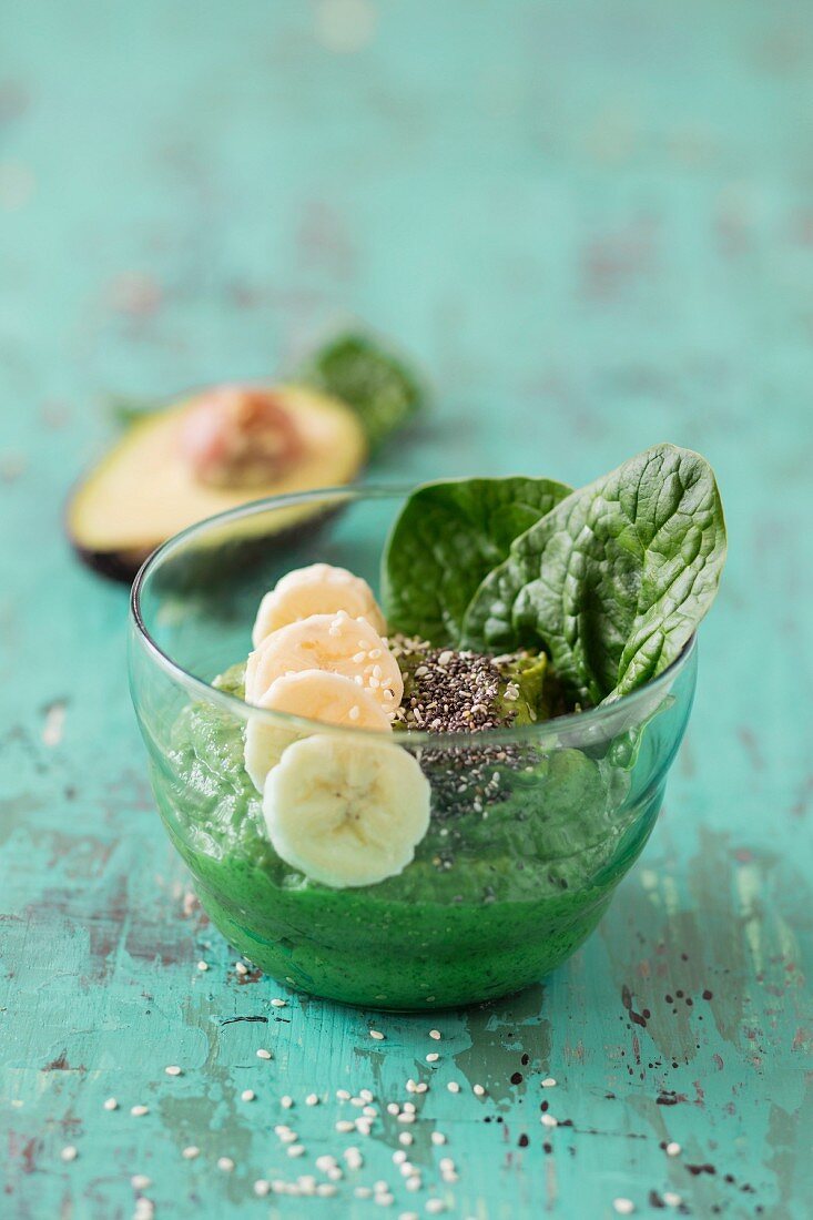 A smoothie bowl with spinach, avocado and banana