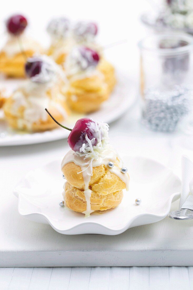 Cream puff with cherry and white glaze