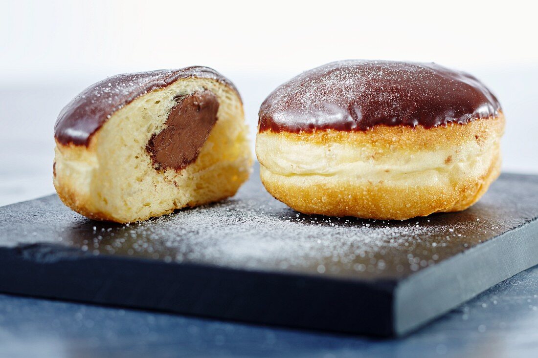 Nougat doughnuts with chocolate glaze, whole and halved