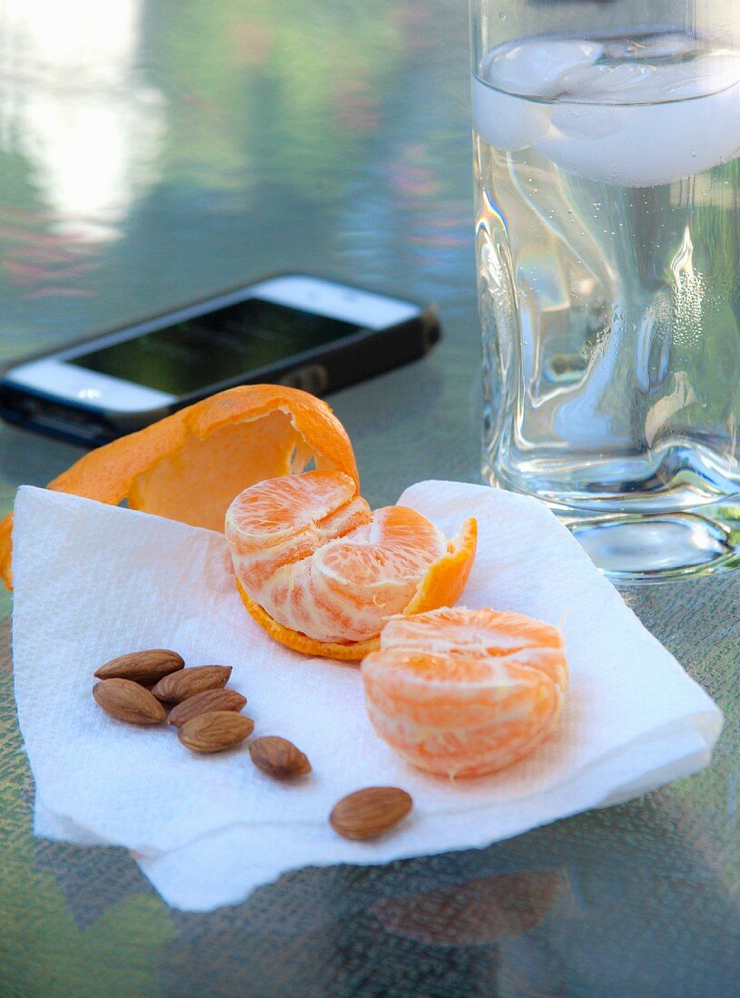 A mandarin and almonds as a snack