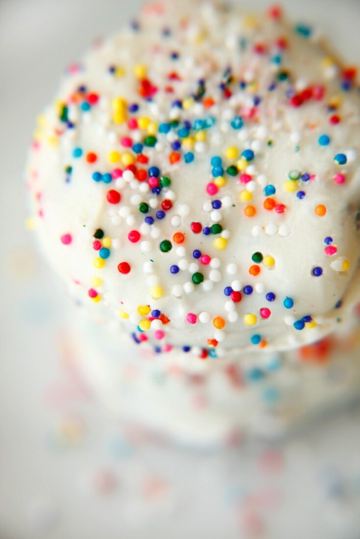 Butter biscuits with white glaze and colourful sugar sprinkles