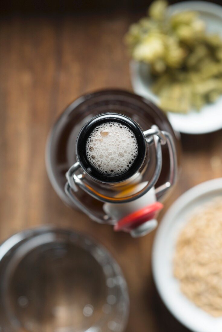 A flip-top bottle of beer with ingredients