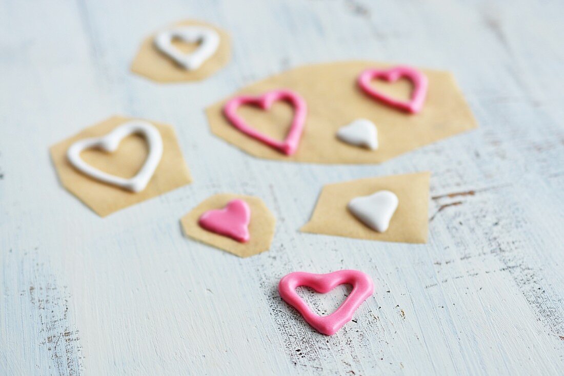Piped sugar hearts on baking paper