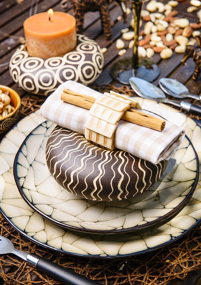A Christmas place setting with elegant African decorations on a garden table