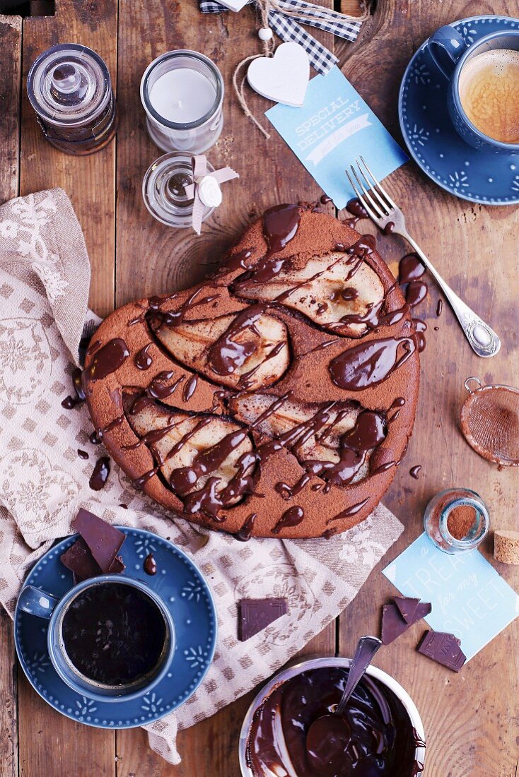 Pear and chocolate cake with coffee on a wooden table