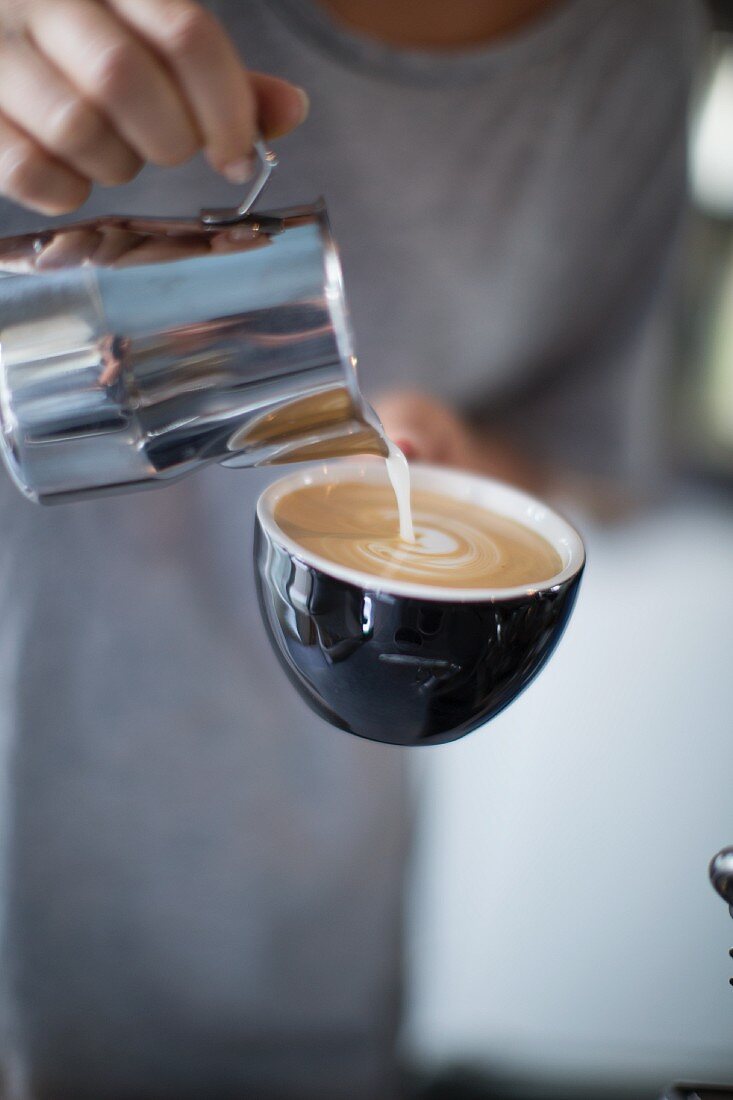 A cappuccino being made at the coffee roasting house 'Bonanza Coffee Heroes', Berlin, Germany