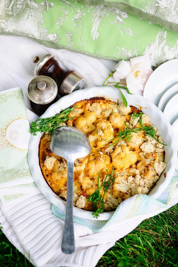 Cauliflower crumble with bacon and cheese for a picnic in a field