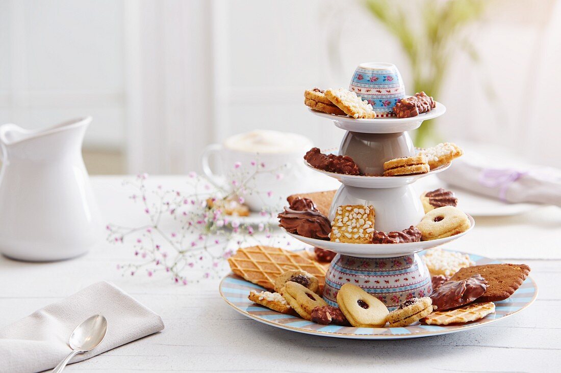 Various biscuits on a cake stand made of overturned cups and plates