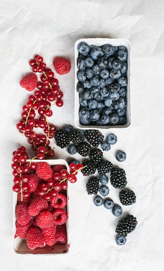 Various berries in cardboard punnets and in between