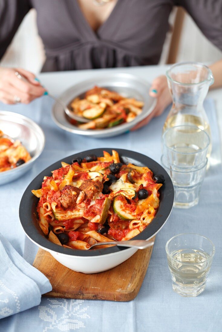 Penne pasta with meatballs, vegetables and olives