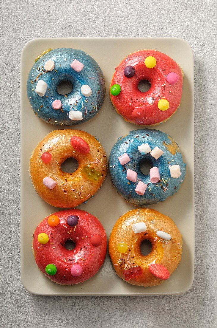 Colourful doughnuts decorated with marshmallows and chocolate beans