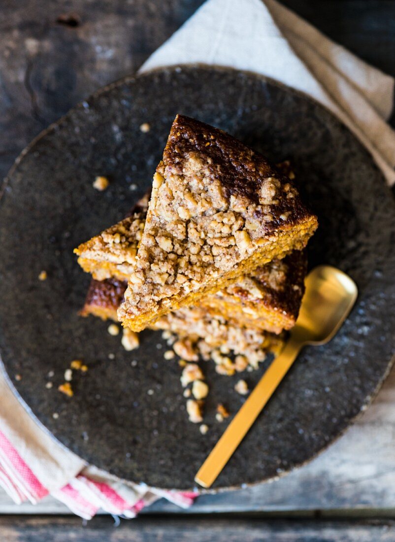 Slices of freekeh crumble cake stacked on a plate