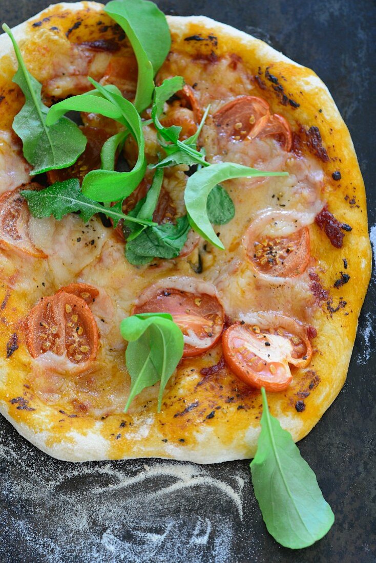 Pizza mit Tomaten, Mozzarella und Rucola