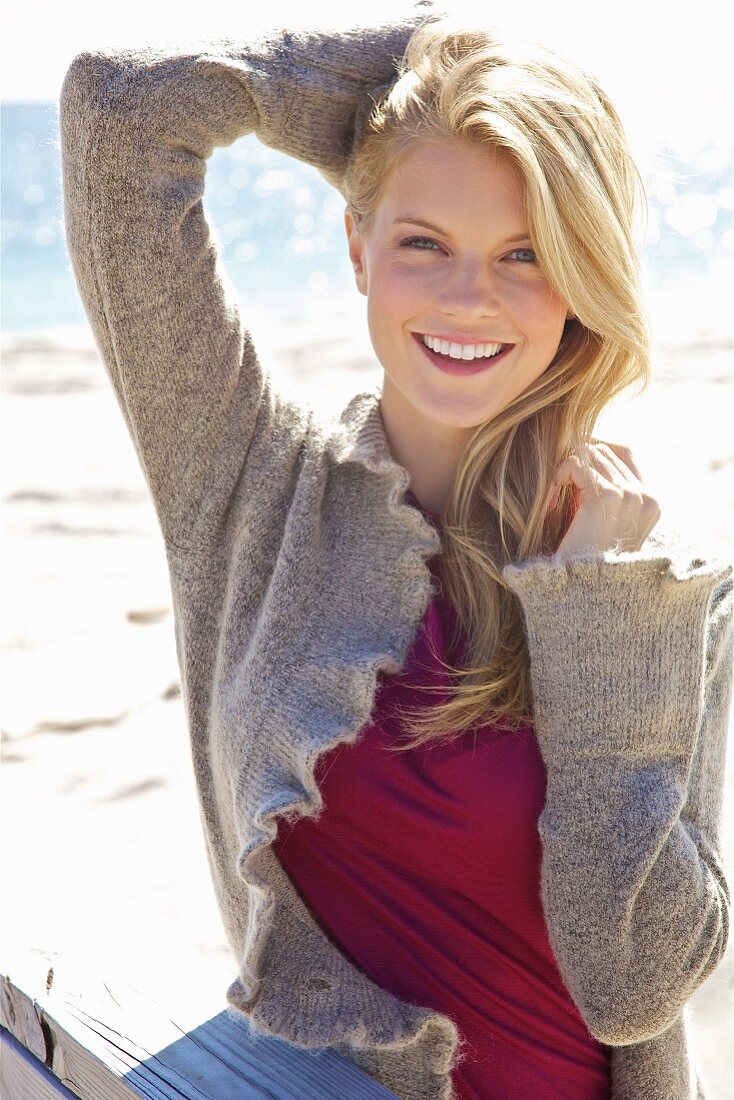 Young blonde woman wearing jeans and cardigan