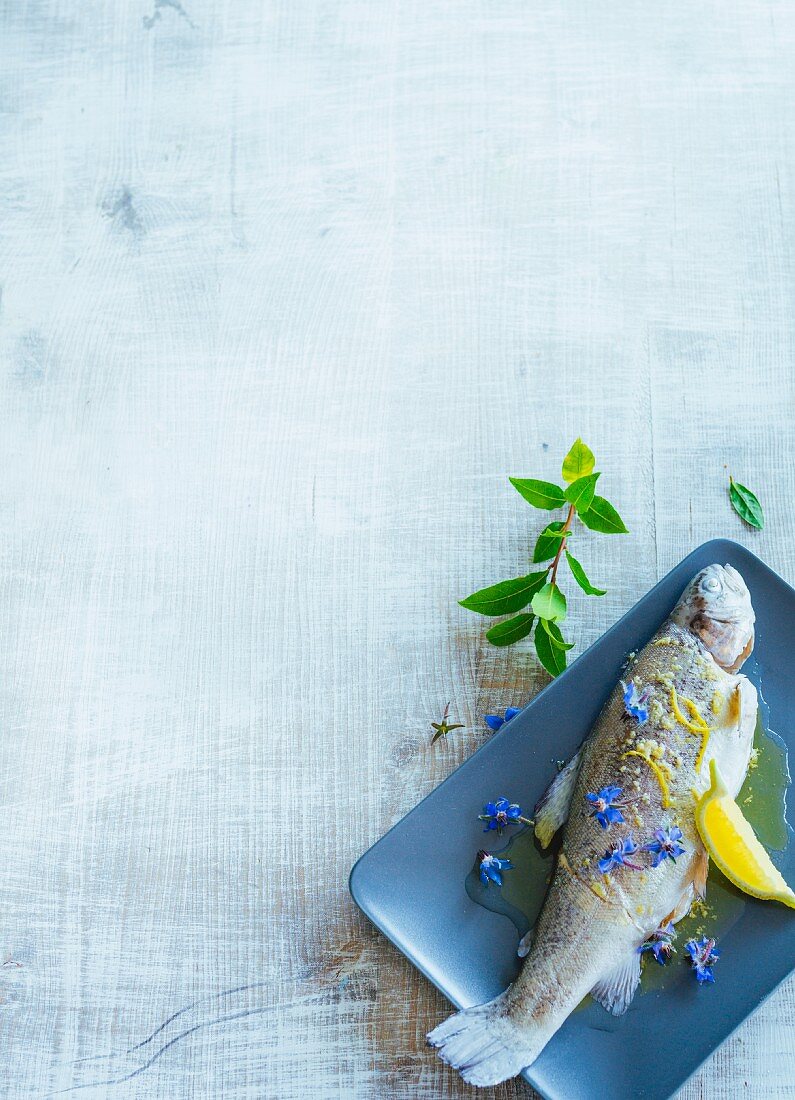 Trout blue with lemon and borage flowers