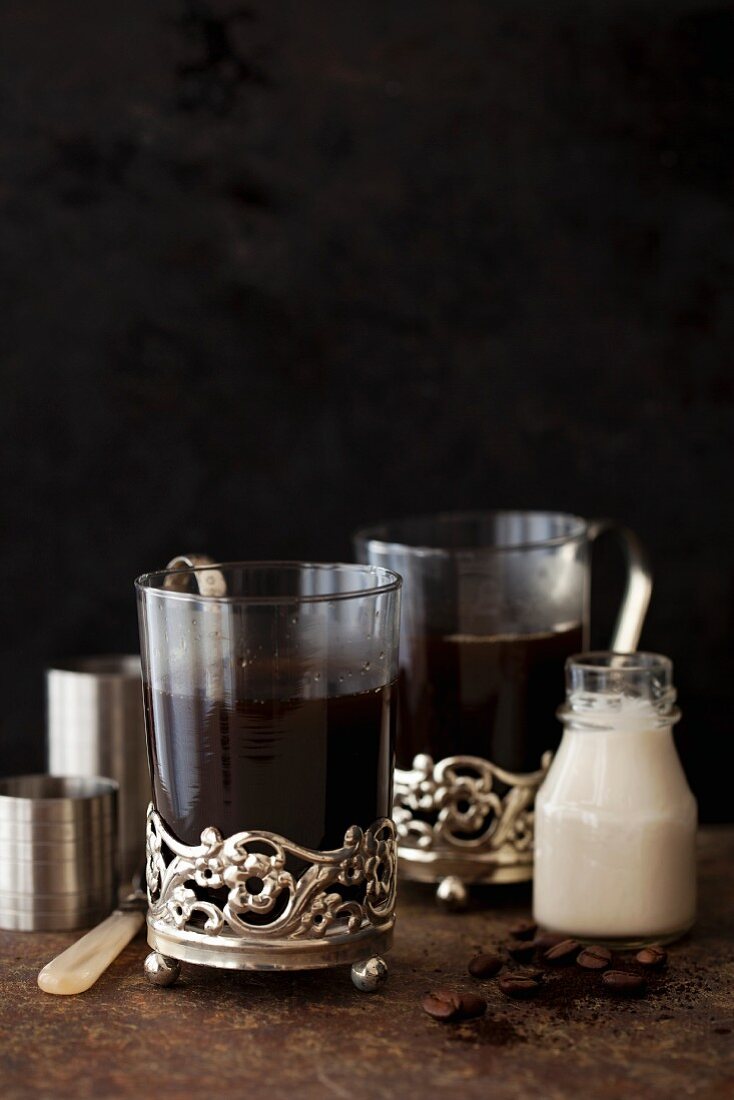 Black coffee with liqueur, coffee and a measuring jug