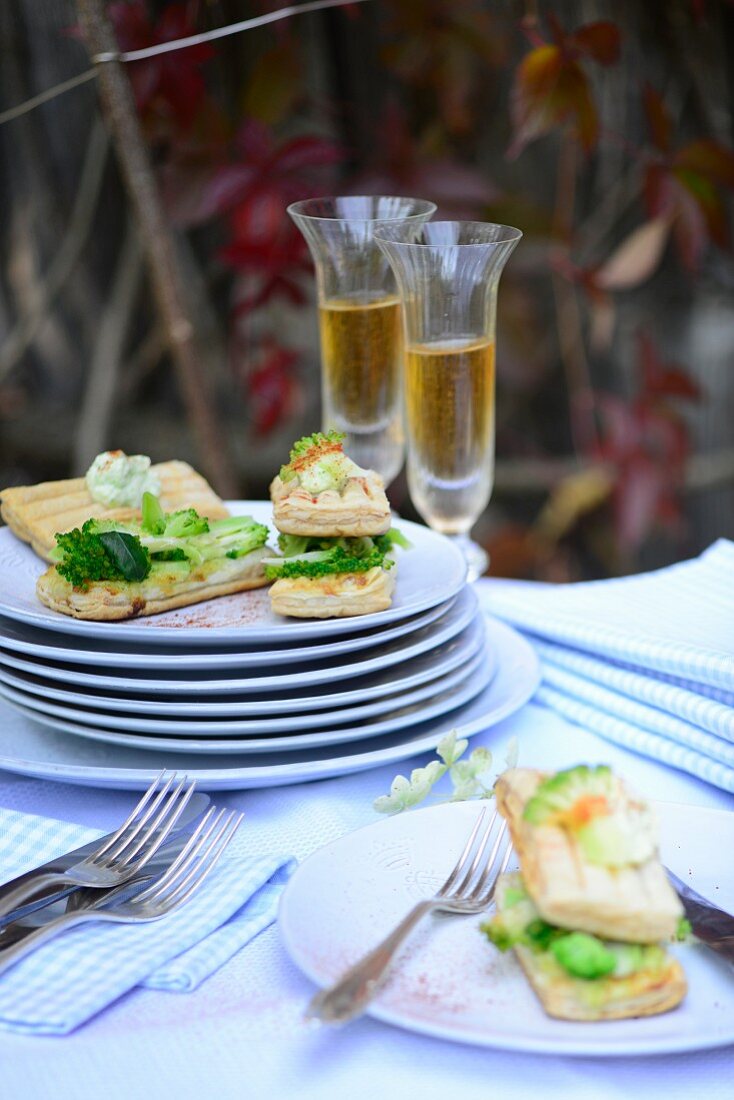 Spicy mille feuilles with broccoli and cheese on a table outside