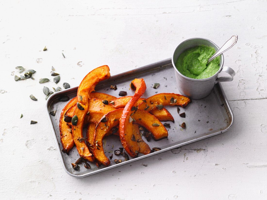 Oven-baked pumpkin wedges with a pea dip