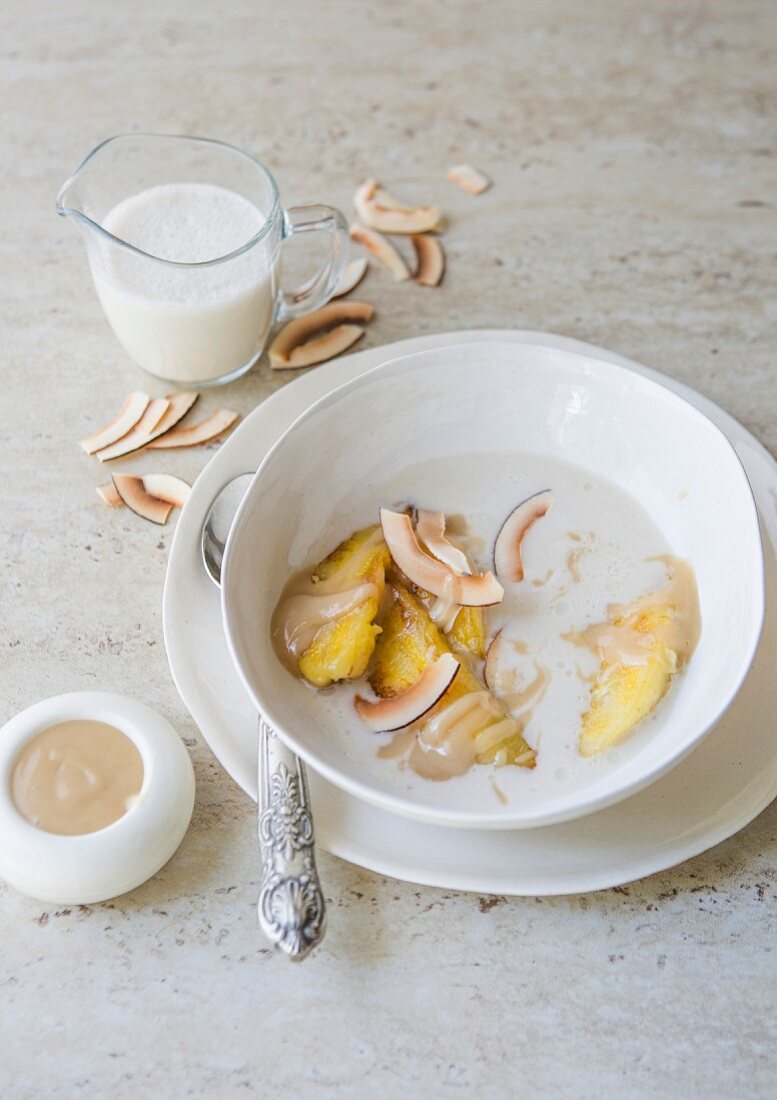 Fried bananas in a coconut and vanilla soup with a nut butter and honey sauce