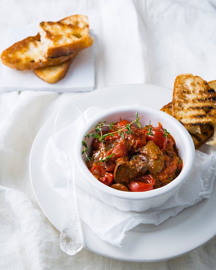 Spicy chicken liver with peri-peri sauce, tomatoes and ciabatta toast