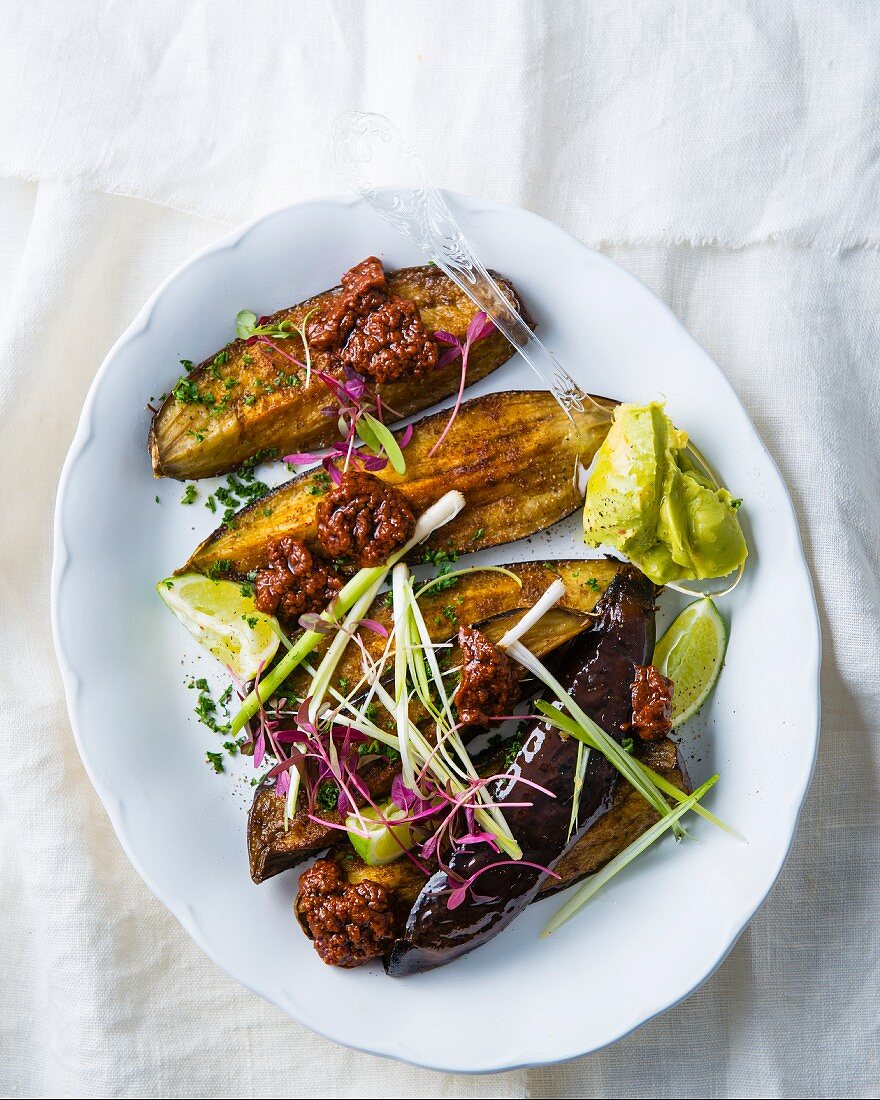 Roasted aubergines with harissa and guacamole