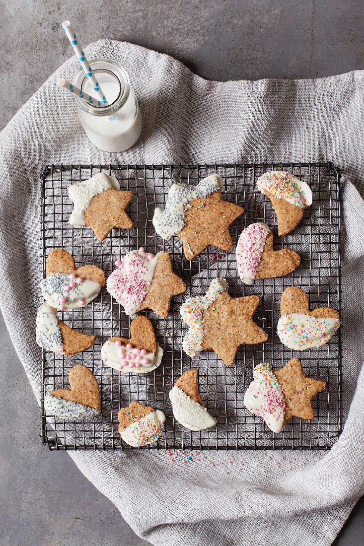 Vegan coconut biscuits with white chocolate glaze and colourful sugar sprinkles