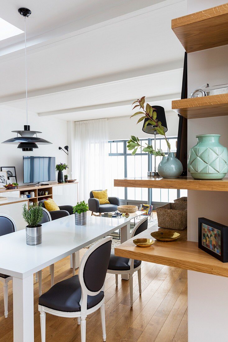 Corner shelves, modern table and Baroque chairs in dining room