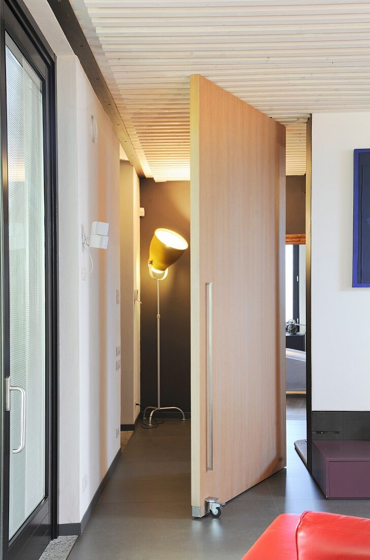 Wooden swivel door in modern apartment