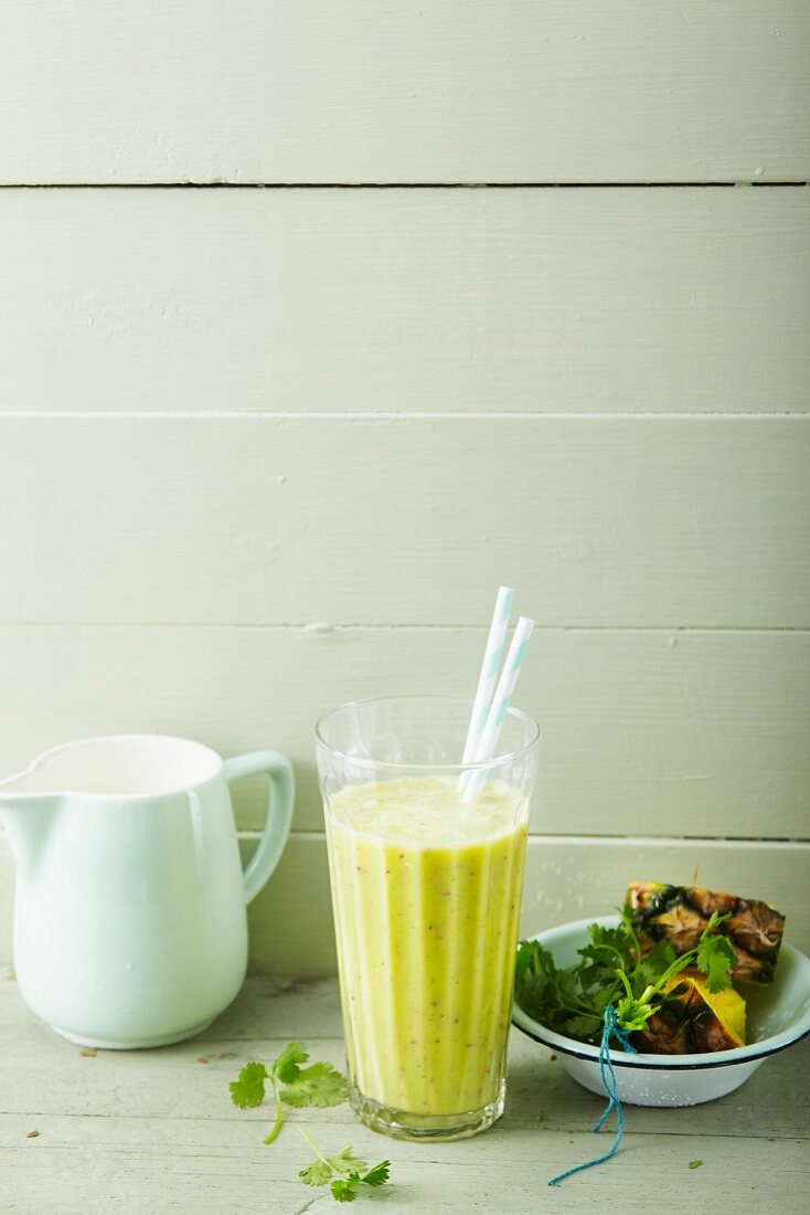 A pineapple and peach smoothie with coriander and coconut oil