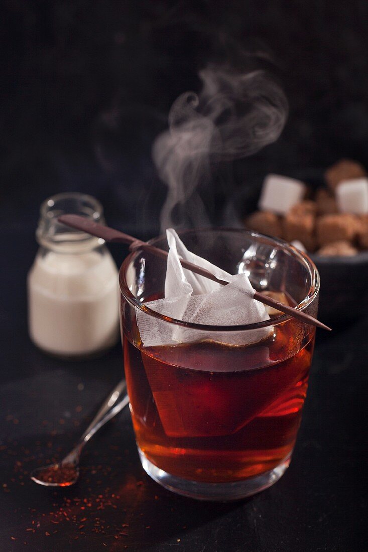 A steaming mug of redbush tea with a teabag