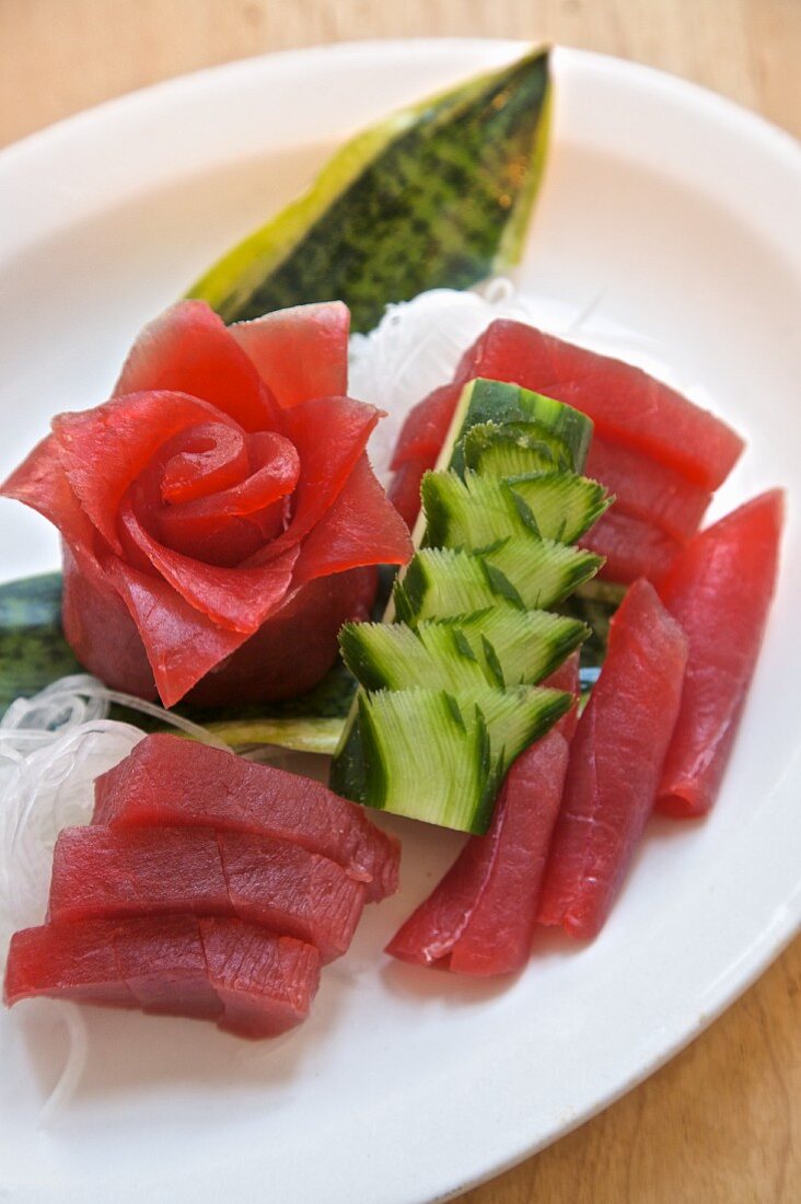 Thunfisch-Sashimi mit kunstvoll geschnittenem Daikon-Rettich und Gurke