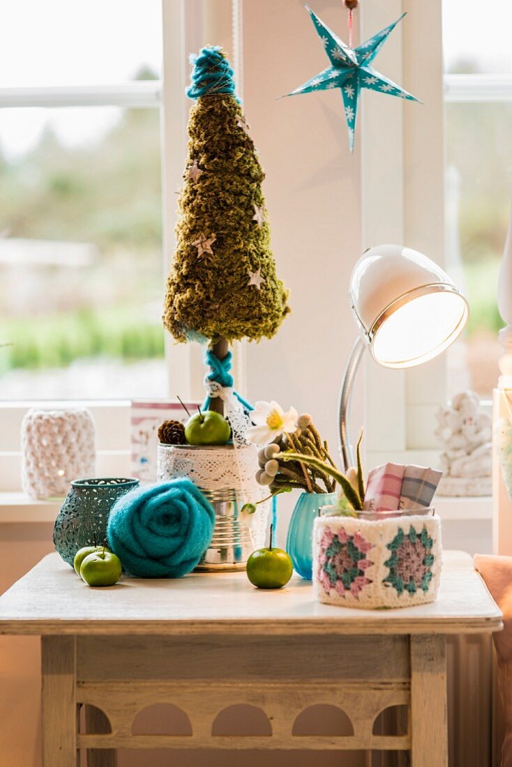 Vintage bedside table festively decorated with pastel needlework