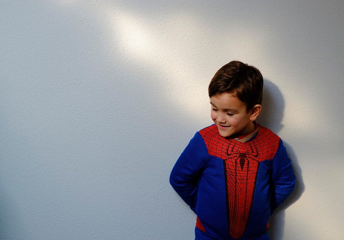 A little boy in a spiderman top
