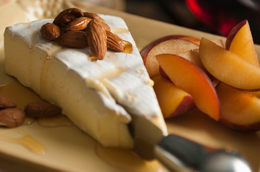 Brie with almonds, honey and red plums