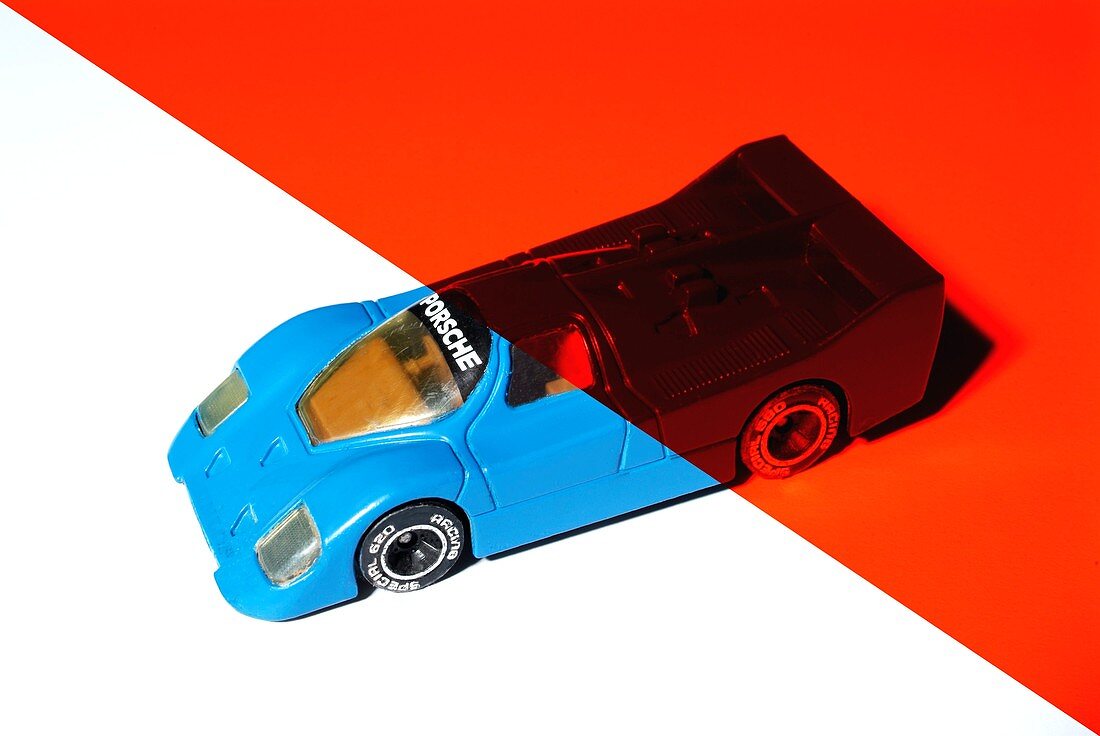 Blue toy car under red light