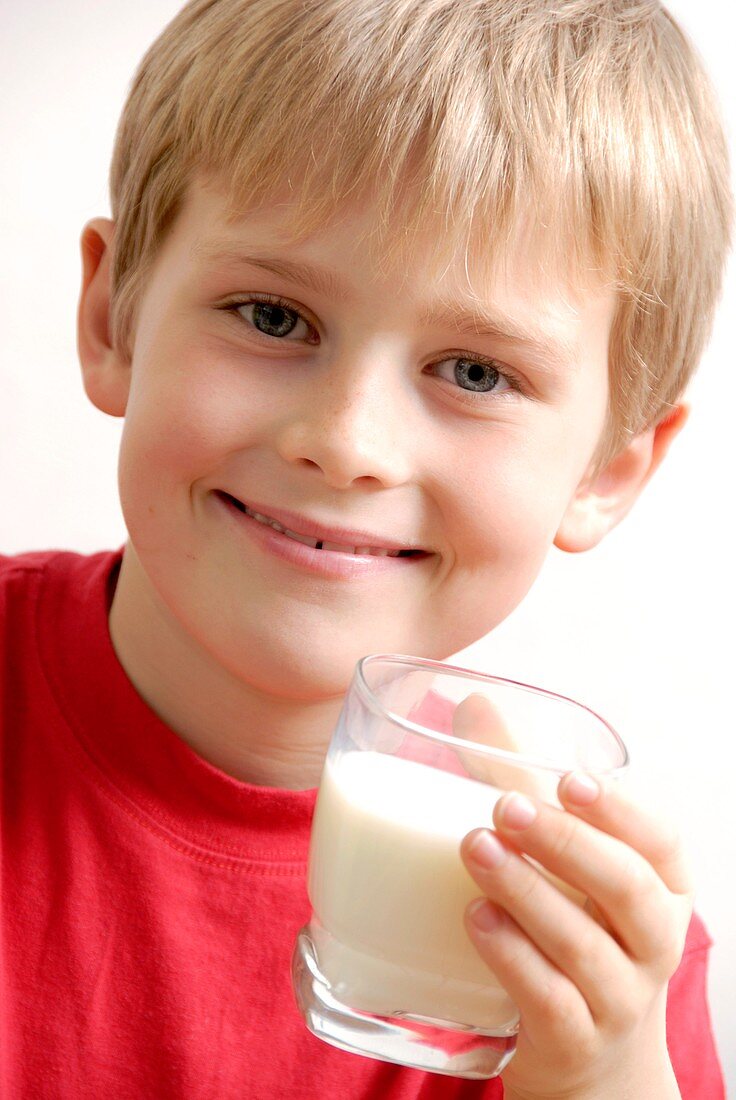 Boy holding a glass of milk