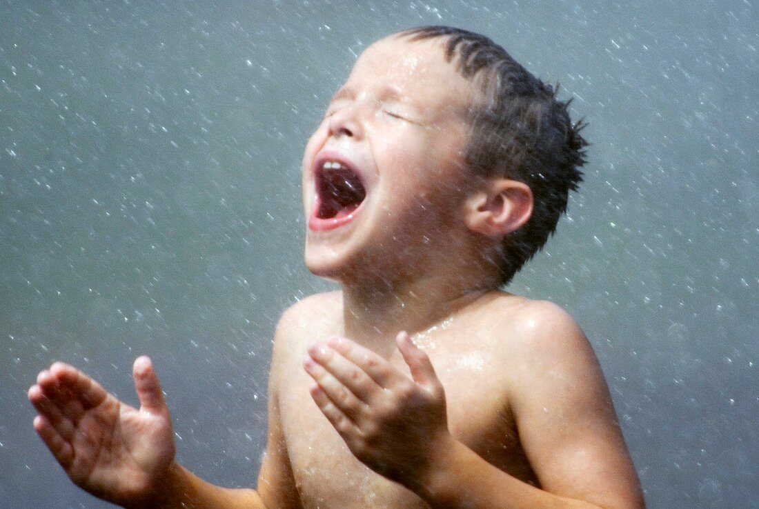 Boy being sprayed with water