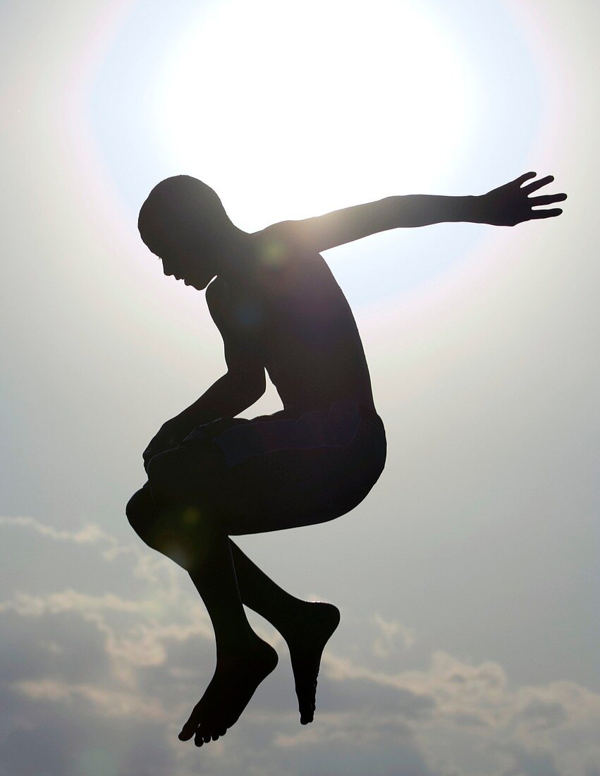 Silhouette of a boy jumping in the air