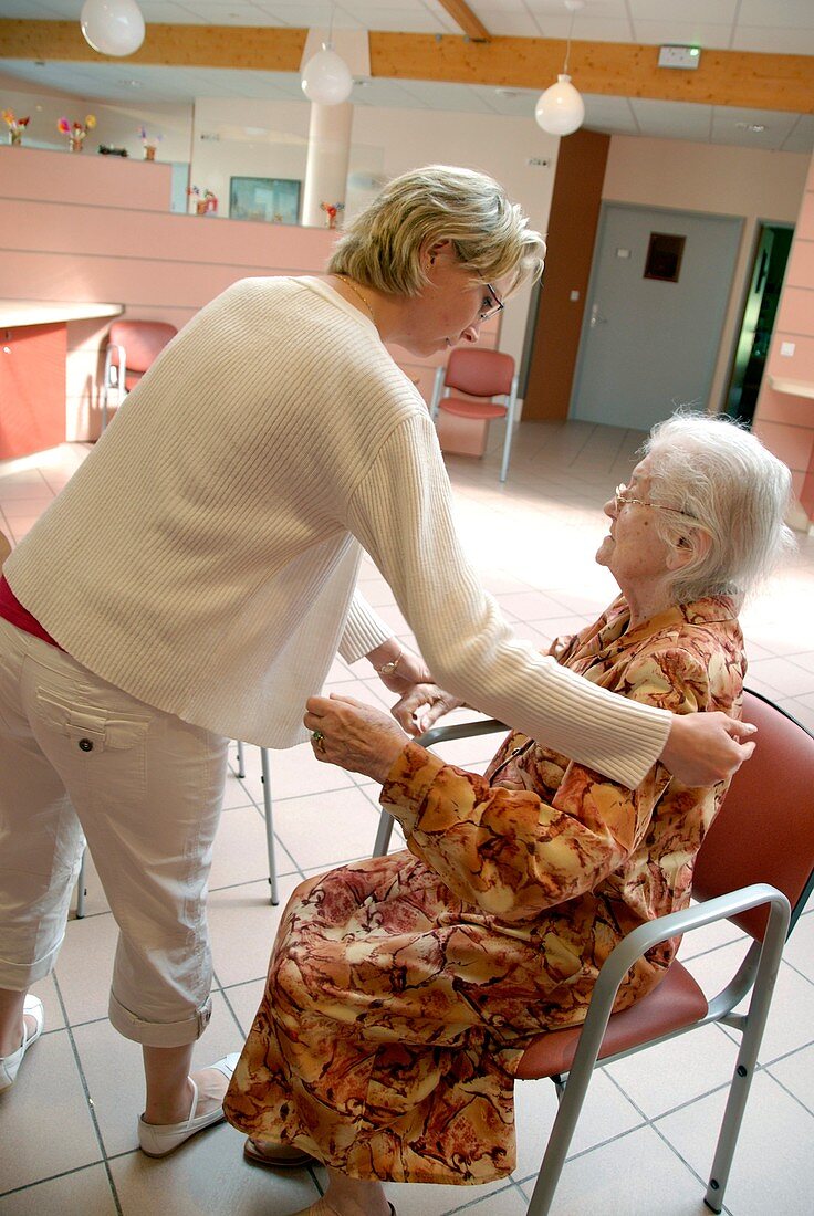 Alzheimer's patient is assisted to walk