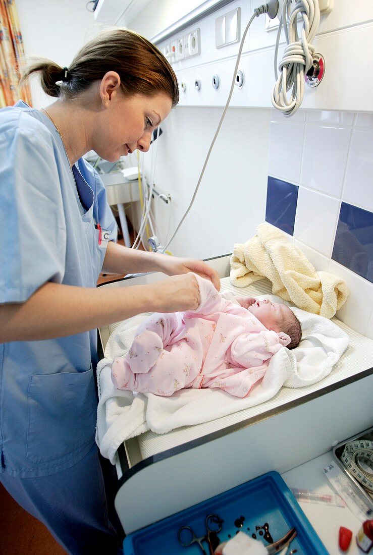 Newborn baby being held