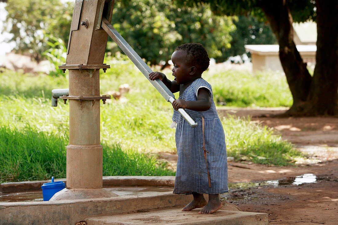 Young girl pumping water,Uganda