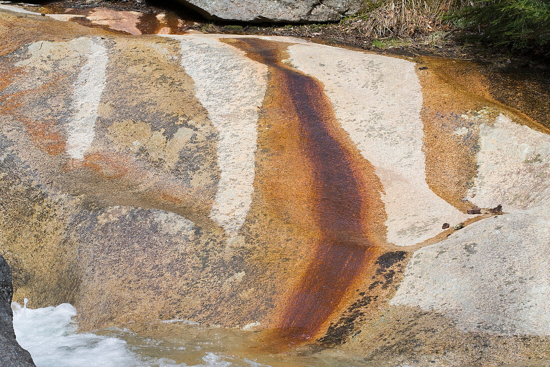 Mineral staining of granite rocks eroded