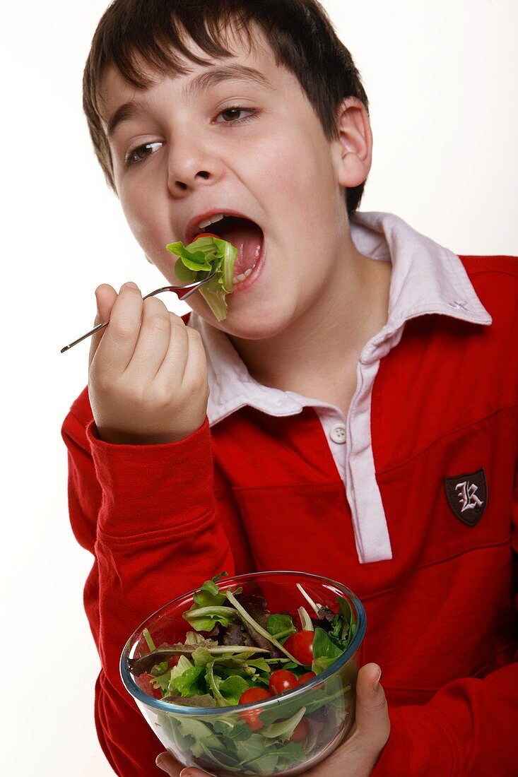 Boy eating a salad