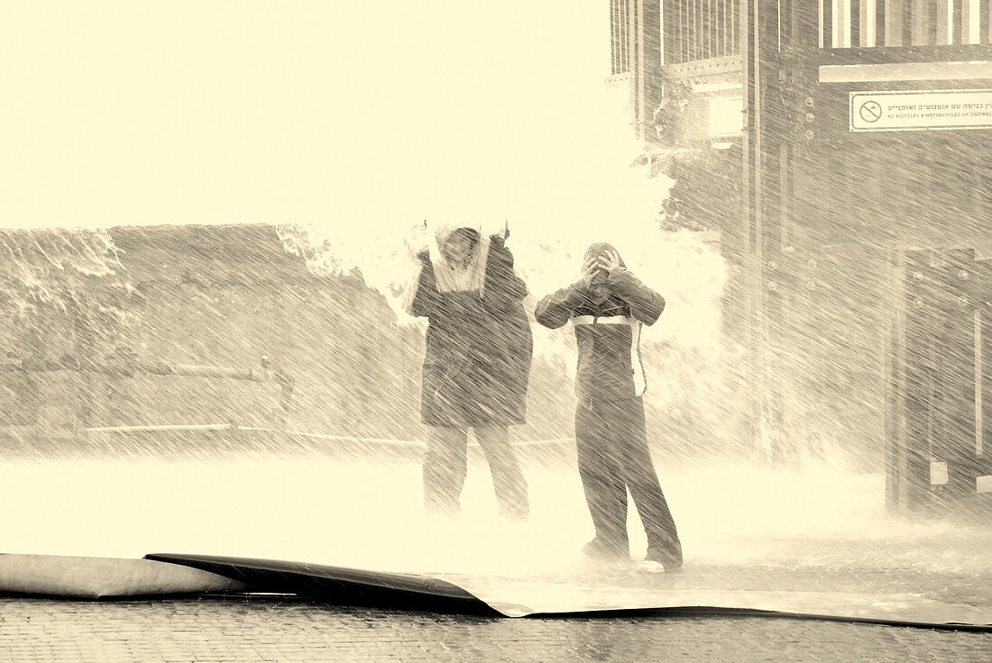 Two people standing in a rainstorm