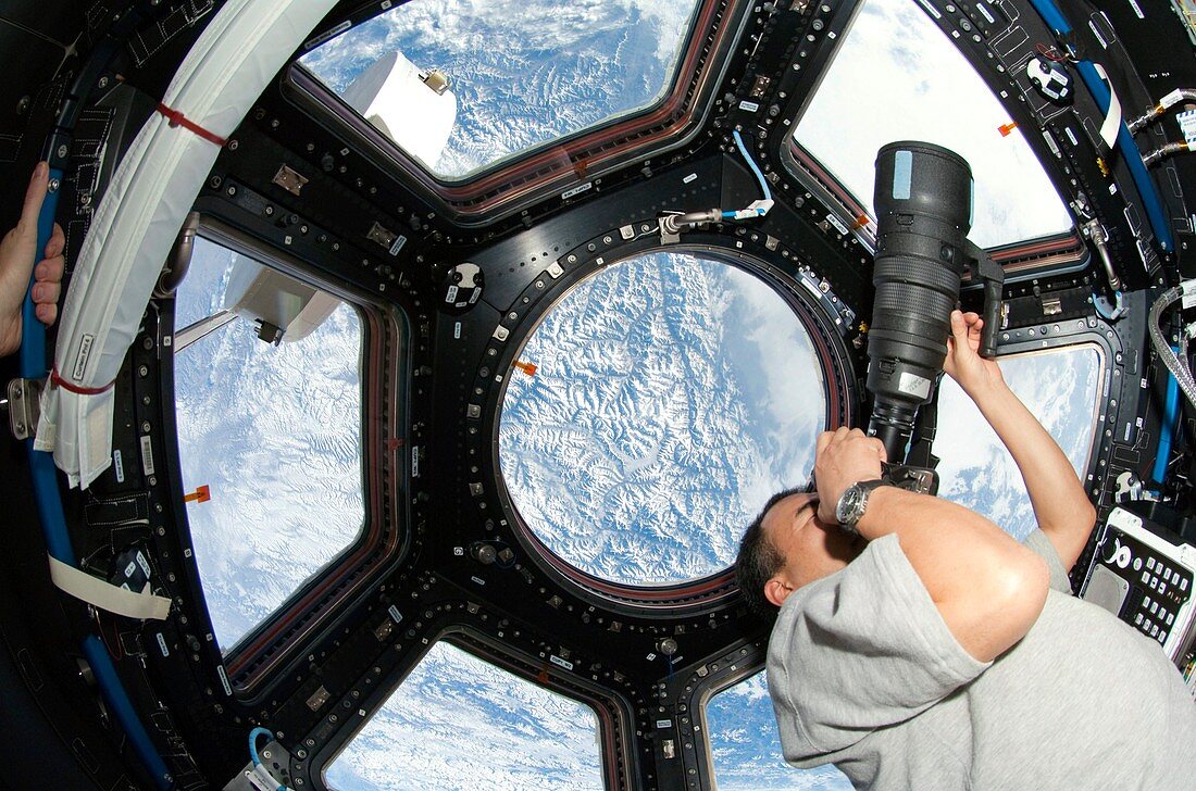 Astronaut photographing aboard the ISS