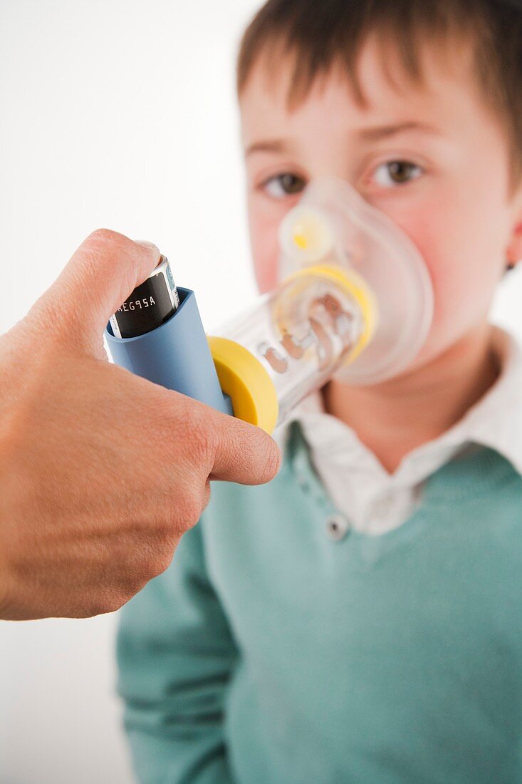 A child using an inhaler used with spacer