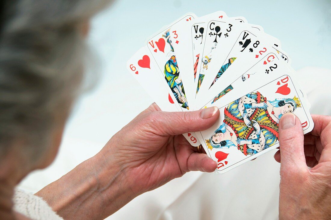 Elderly woman playing cards